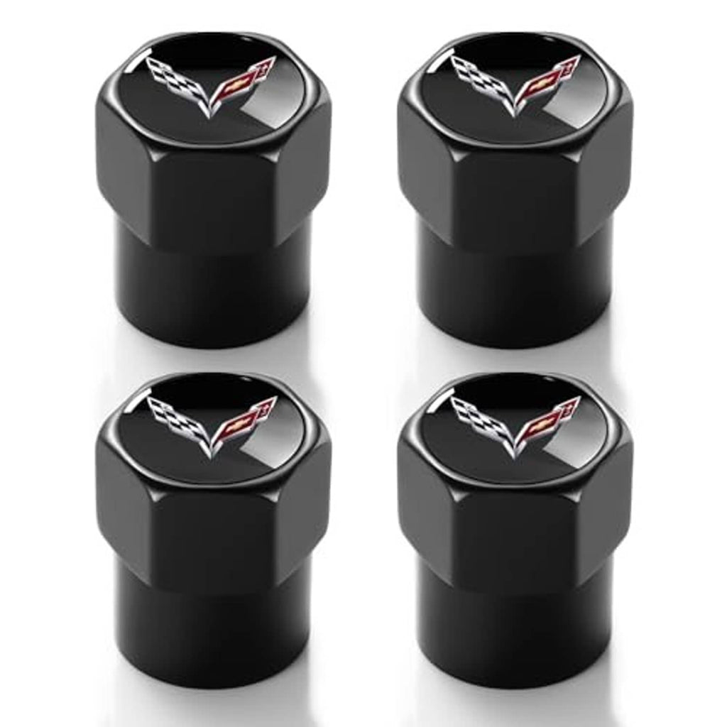 Four black valve stem caps with Corvette logo, metal finish, angled view.