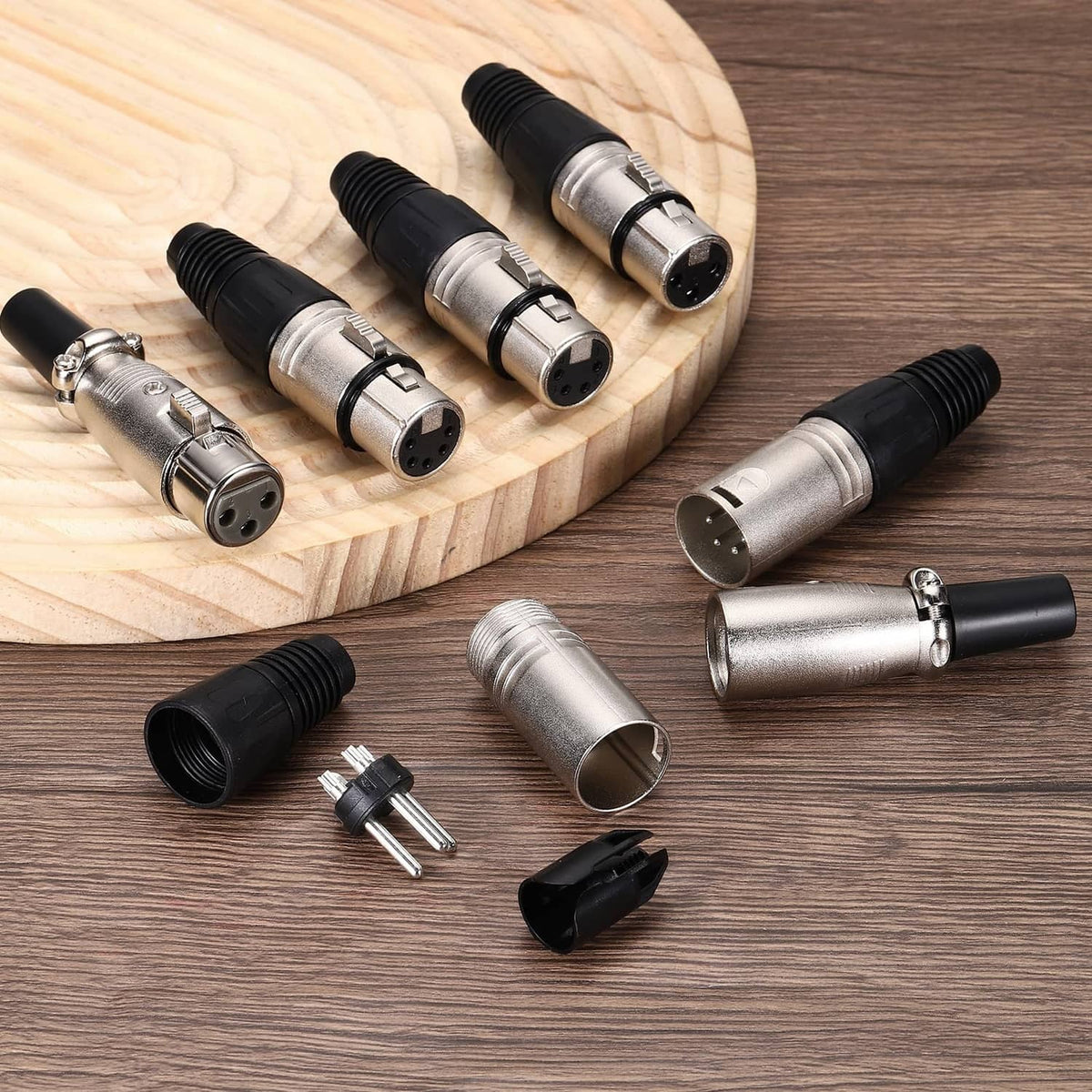 Set of 4-pin XLR female connectors with black grips, silver metal shells, and pin parts