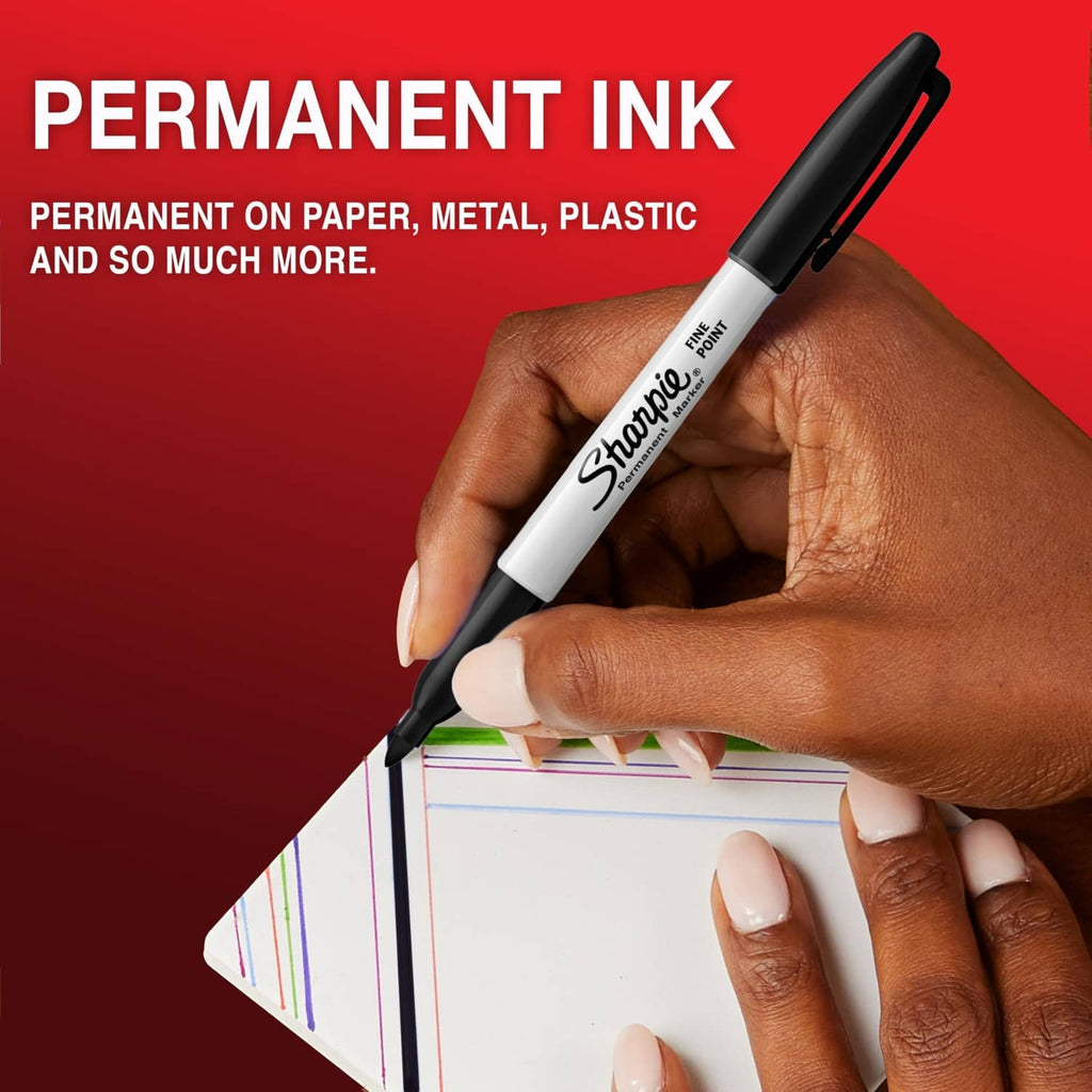 Fine-point permanent marker with dark tip held in a hand above a paper drawing