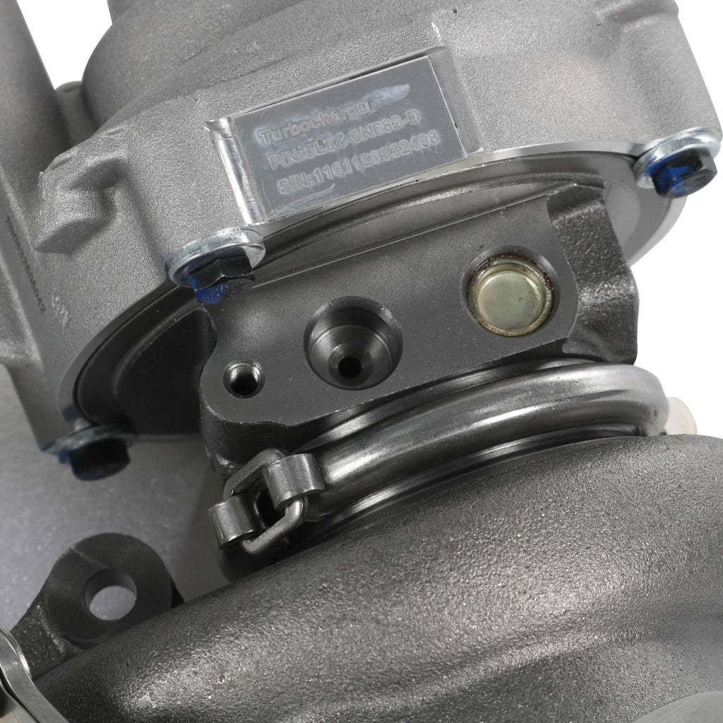 Turbocharger label and clamp hardware on silver-gray housing.