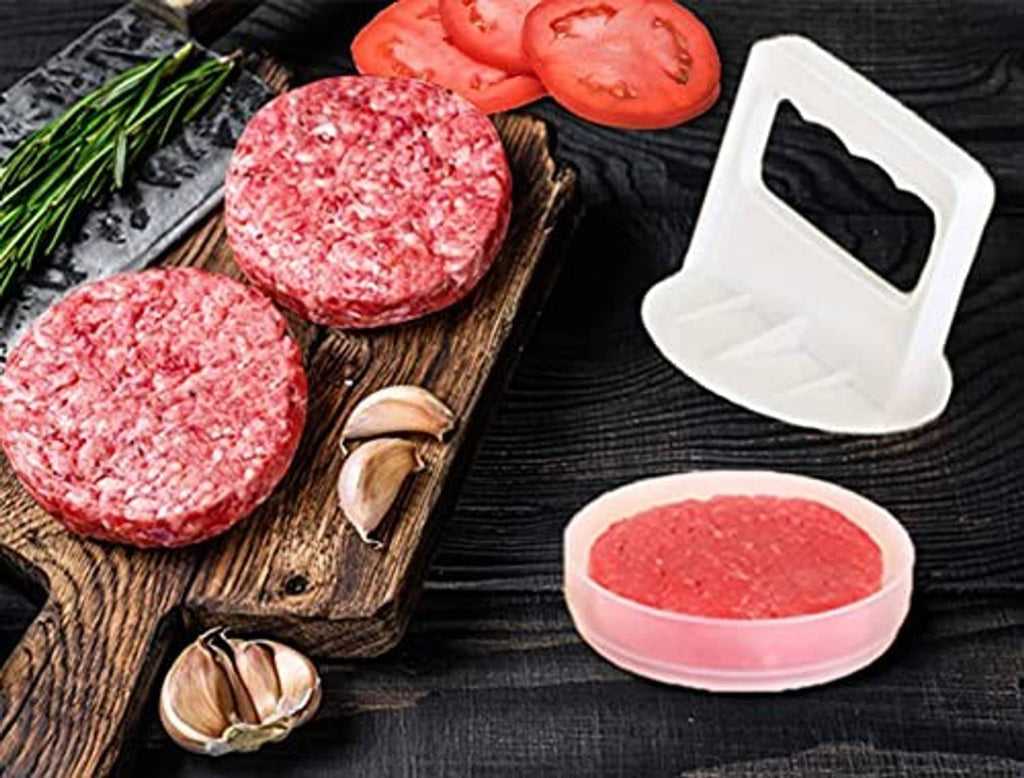 Raw burger patties with white patty press and freezer container lids on tray