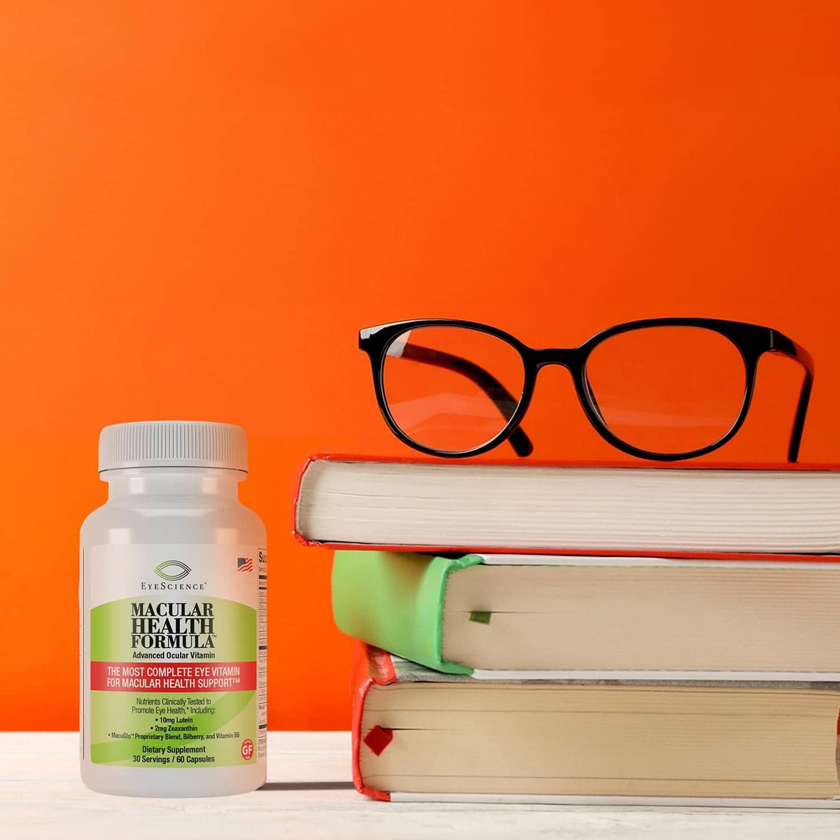 Macular Health Formula bottle next to eyeglasses and books