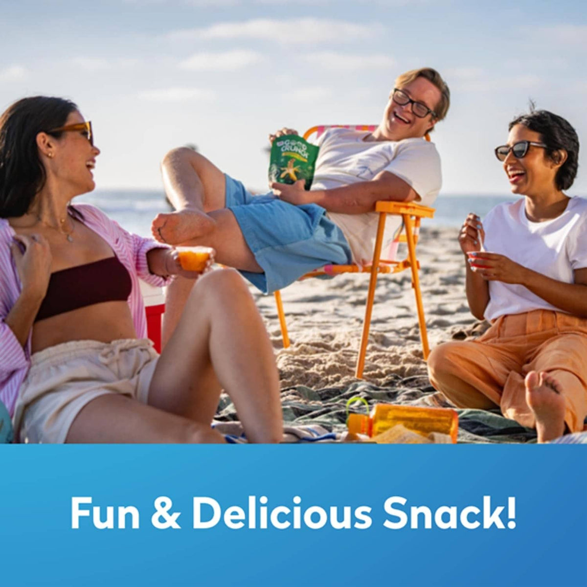 Group of friends at the beach with fruit cups for snacking