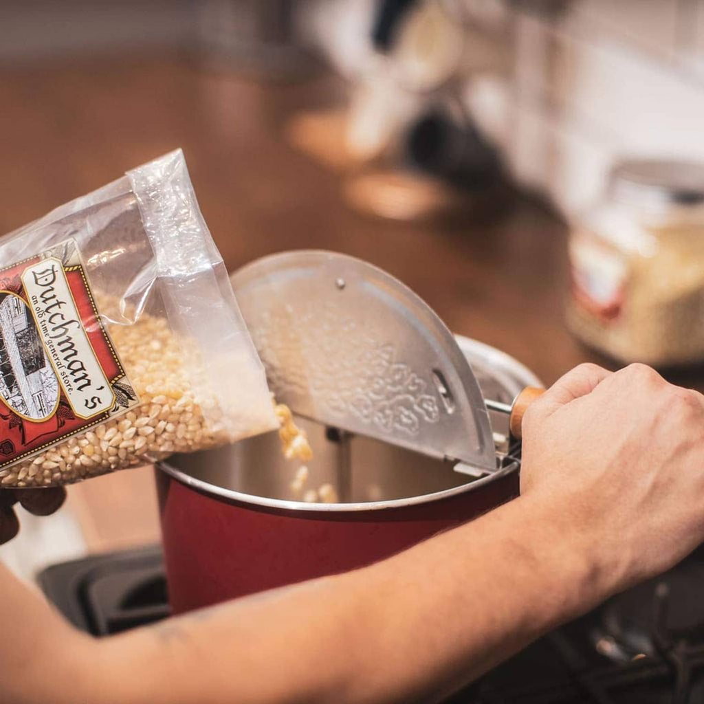 Pouring Dutchman's white popcorn kernels into a saucepan