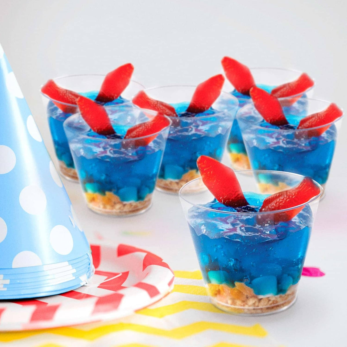 Swedish Fish gummy cups with blue gelatin and red fish gummies on top