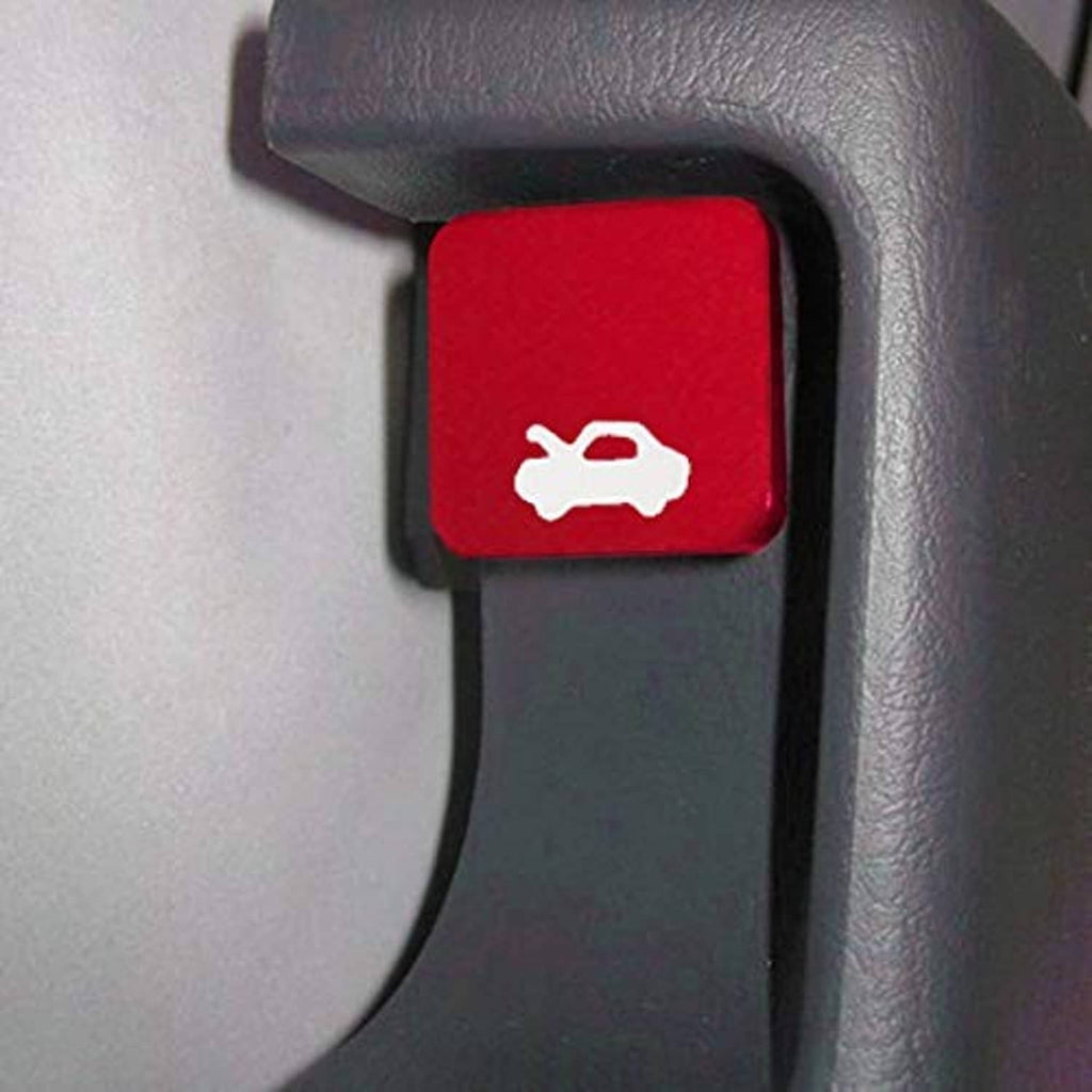 Red hood latch release handle button with wrench icon on light dashboard trim.
