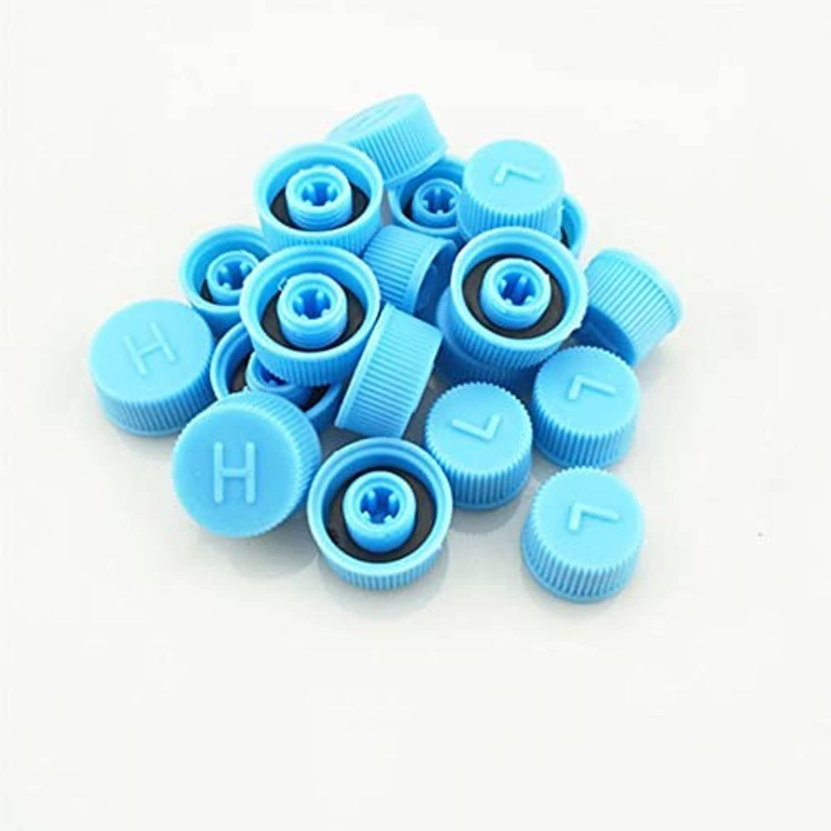 Light blue A/C valve caps pile with raised H and L letters and blue valve cores