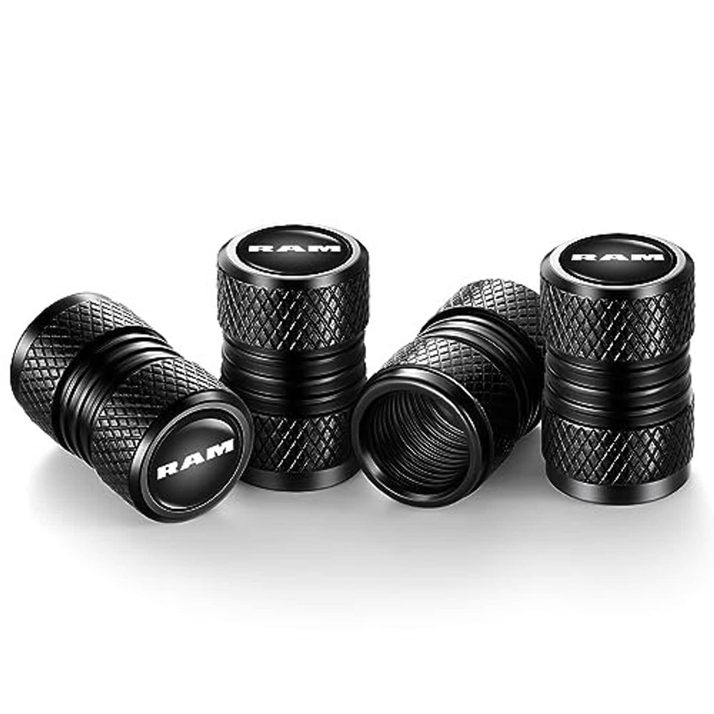 Four black RAM tire valve stem caps with knurled grip, ribbed sides, logo caps