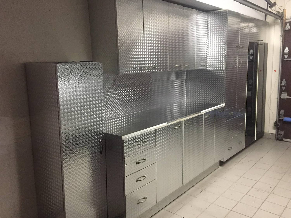 Diamond-plate metallic vinyl wrap panels on garage cabinets and drawers