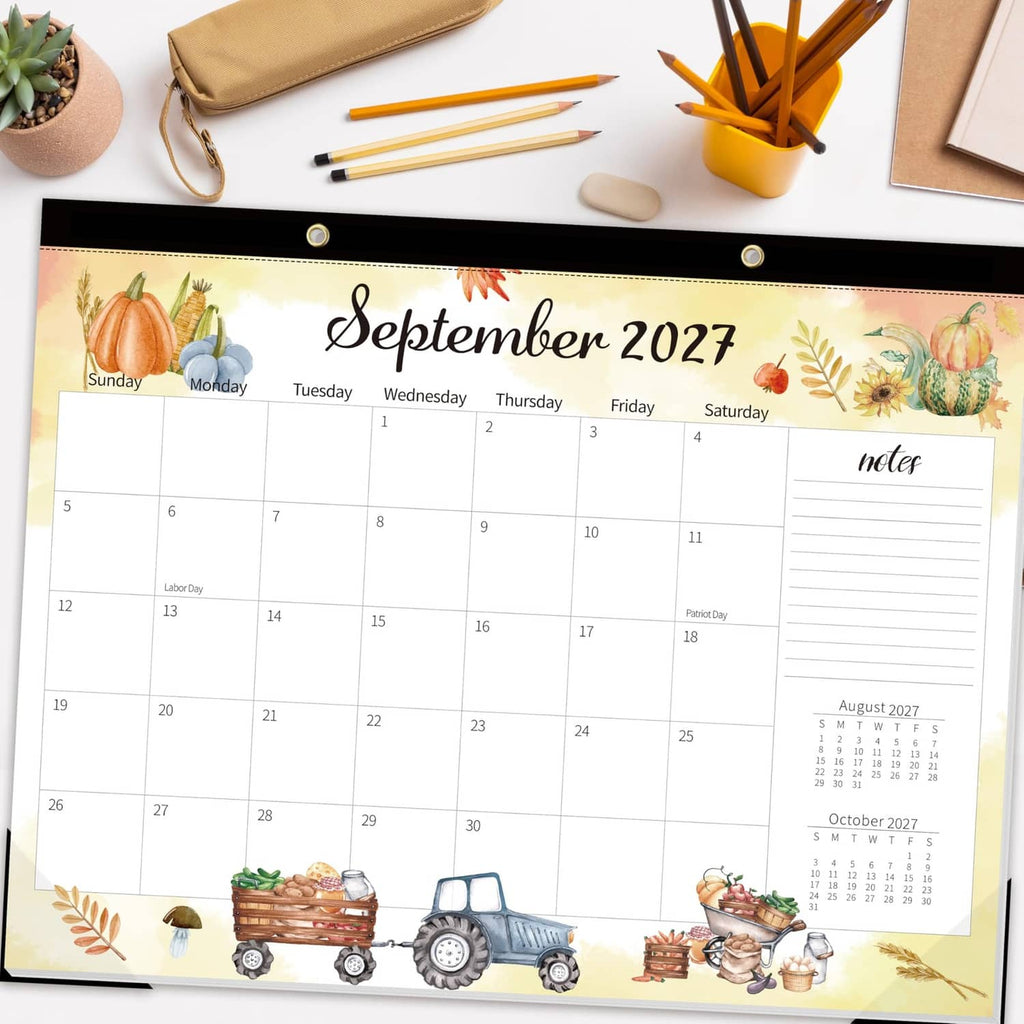 Large desk calendar page showing September 2027 with farm truck illustration and writing grid