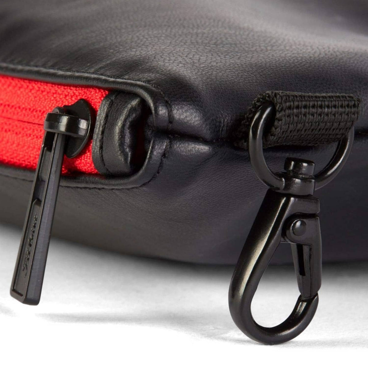 Titleist black golf pouch detail: zipper, carabiner clip, red interior lining