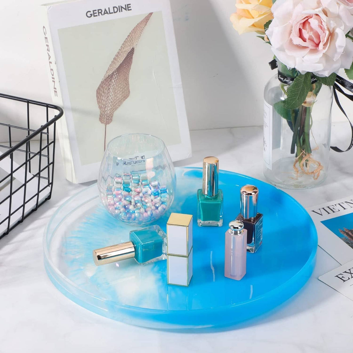 Large round resin tray mold with blue resin surface and clear casting accessories