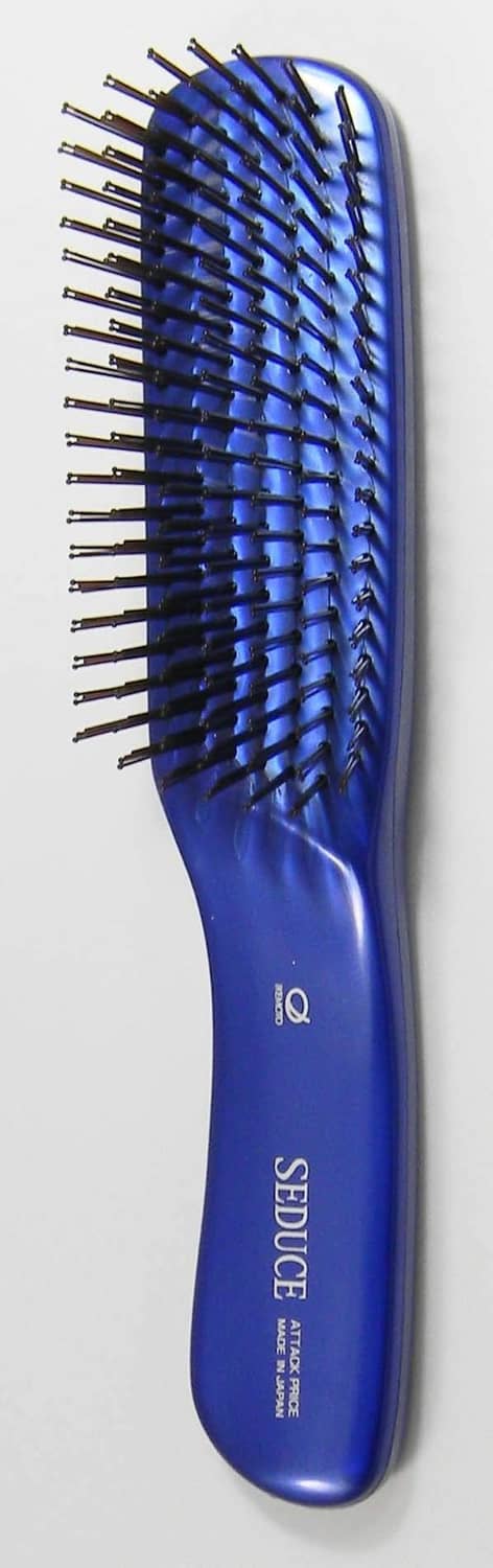 Blue paddle hair brush (L) with long bristle rows and curved handle, angled view