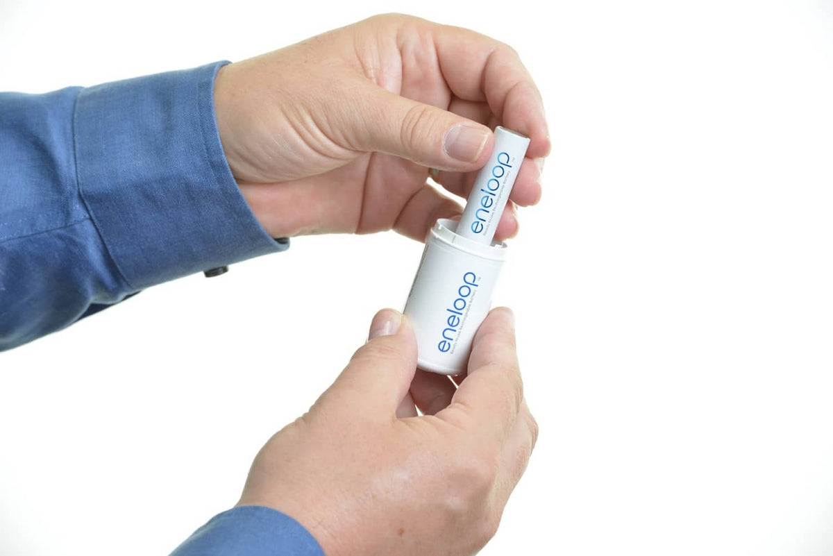 Hands inserting an eneloop D spacer into a rechargeable battery.