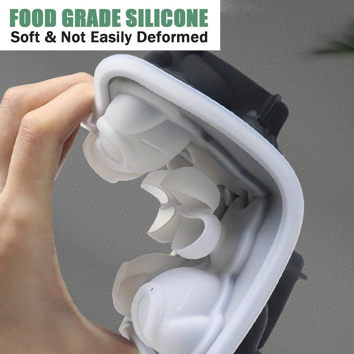 Close-up of hand holding a white silicone cat ice cube mold with cat cavity