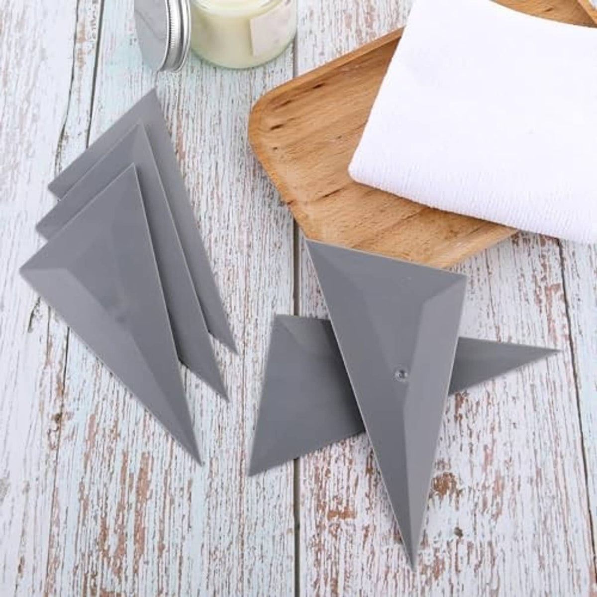 Five gray triangular tint squeegees with pointed tips, stacked and laid out