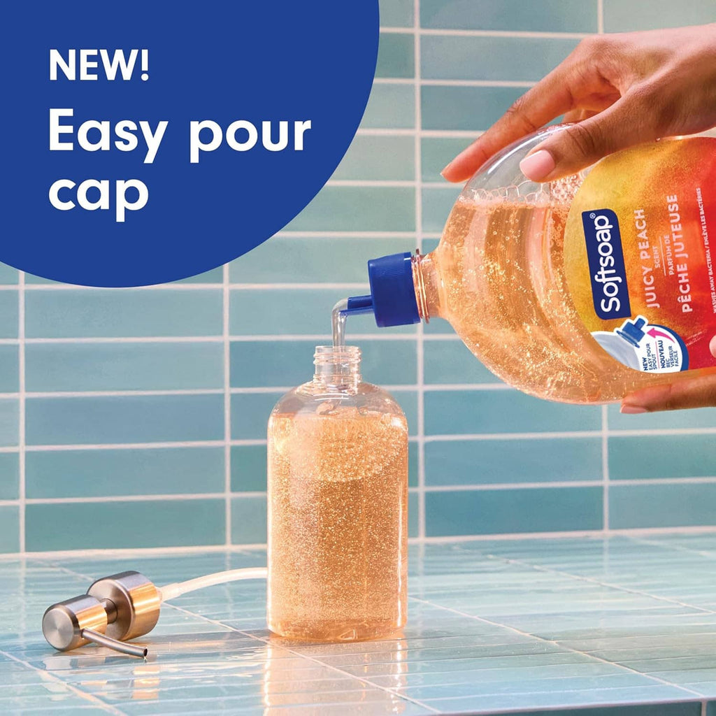 Softsoap juicy peach liquid hand soap bottle pouring into a refill dispenser
