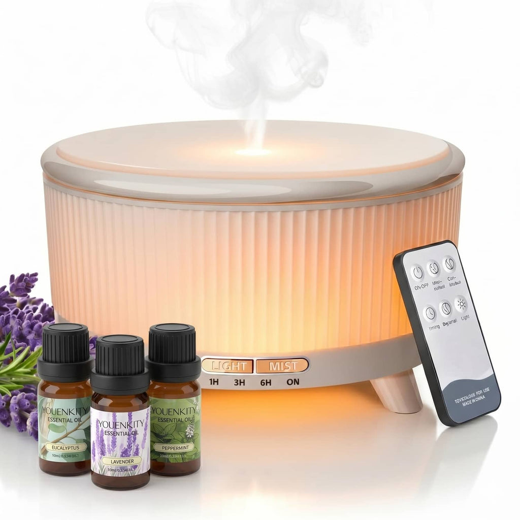 White essential oil diffuser with warm LED light top and included essential oil bottles.