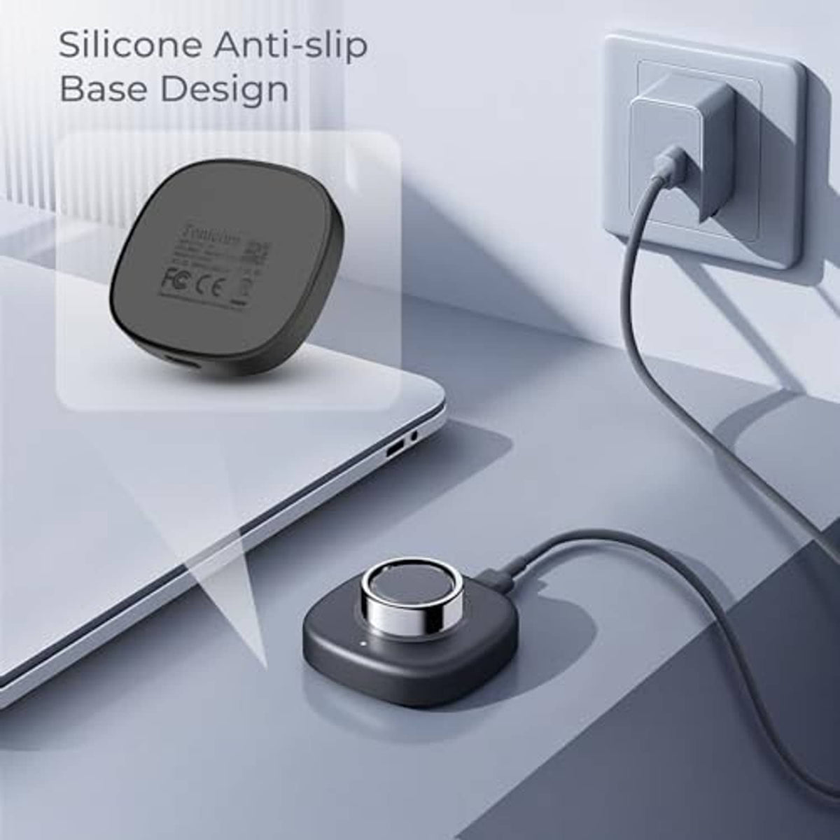 Black charging puck with metal ring top and silicone anti-slip base, plugged in