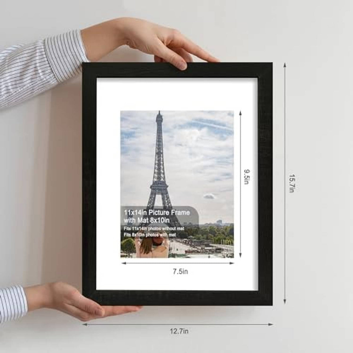 Rustic black 11x14 picture frame held by hands with a landscape photo inside.