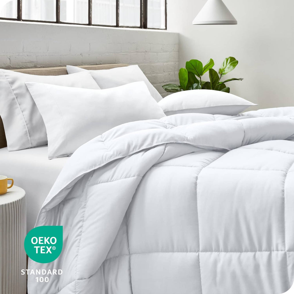 White down-alternative king comforter spread on bed with layered bedding