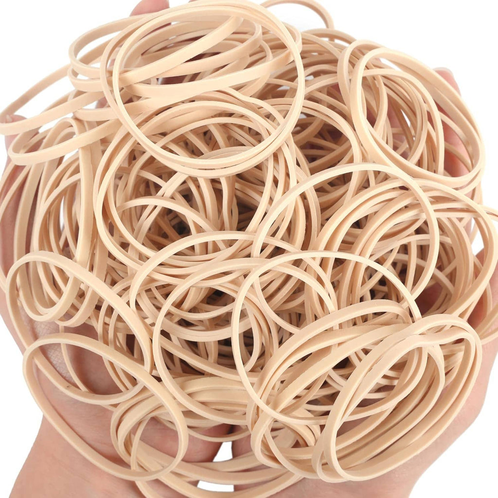 Beige elastic rubber bands close-up with tangled loops in a loose pile