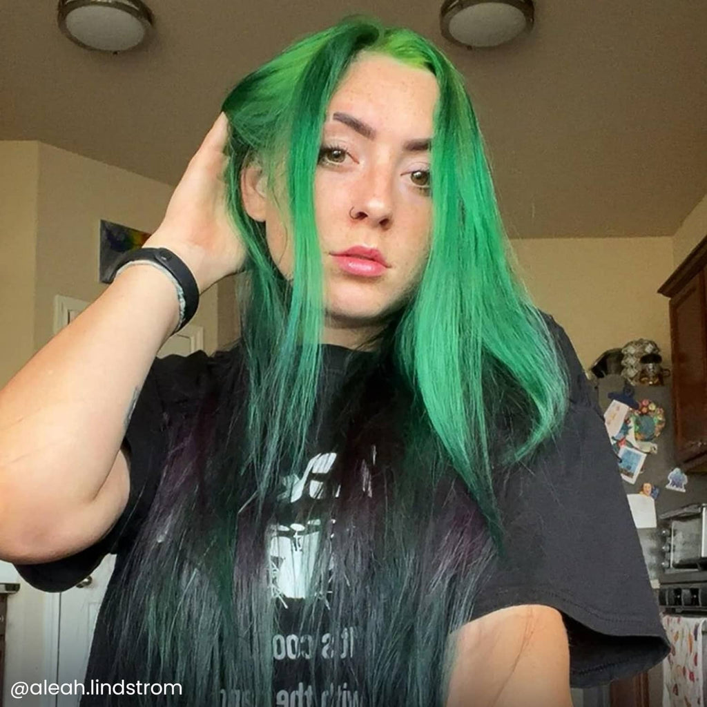 Green dyed hair with bangs and straight length; semi-permanent color result