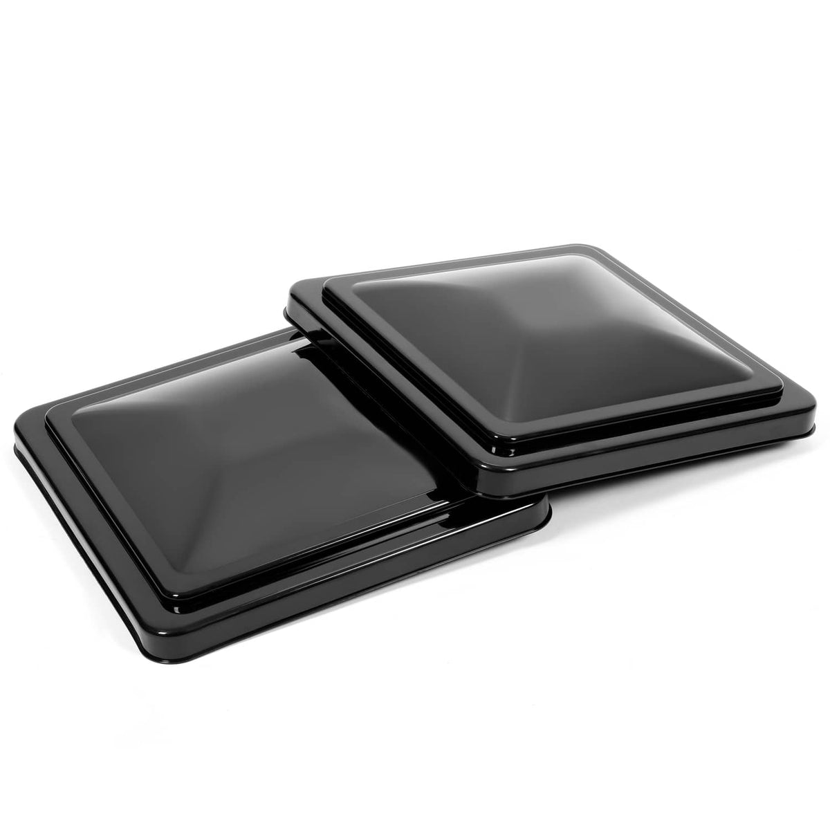 Black RV roof vent covers with hinged lids, one lid shown open