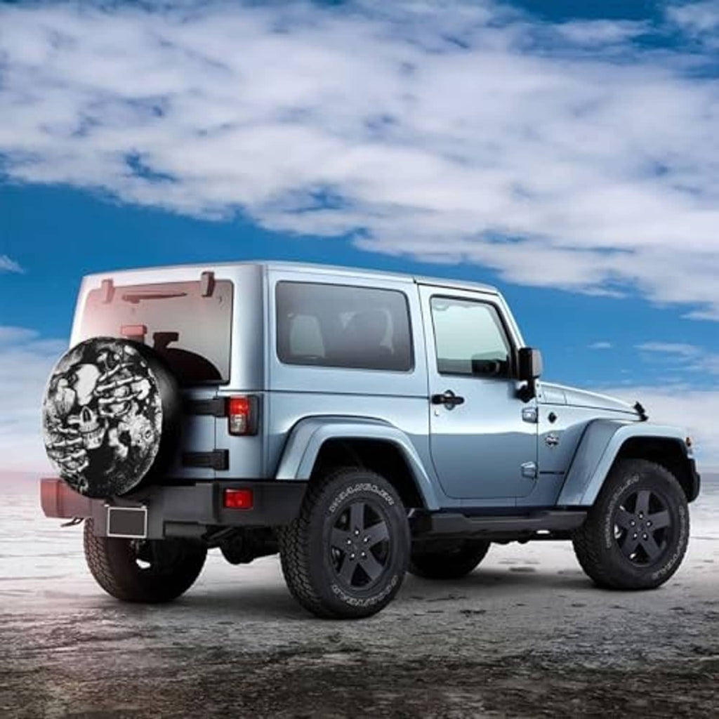 Spare tire cover with skull hands graphic mounted on a Jeep-style SUV
