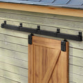 Black sliding barn door track hardware with rollers and wooden door panel
