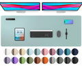Light blue leather-look desk pad with stitched border, shown with office accessories
