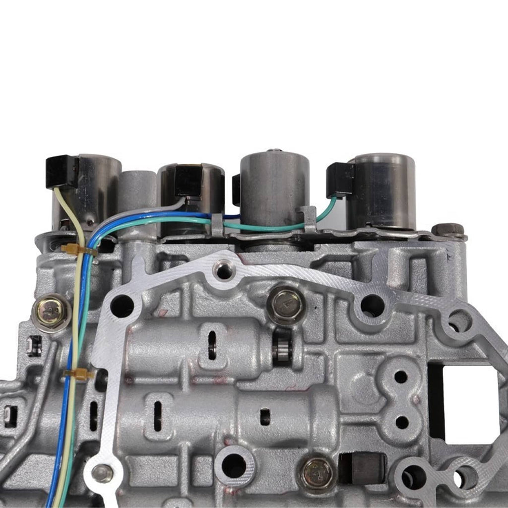 Transmission valve body with solenoid, close-up of housing ports and colored wires