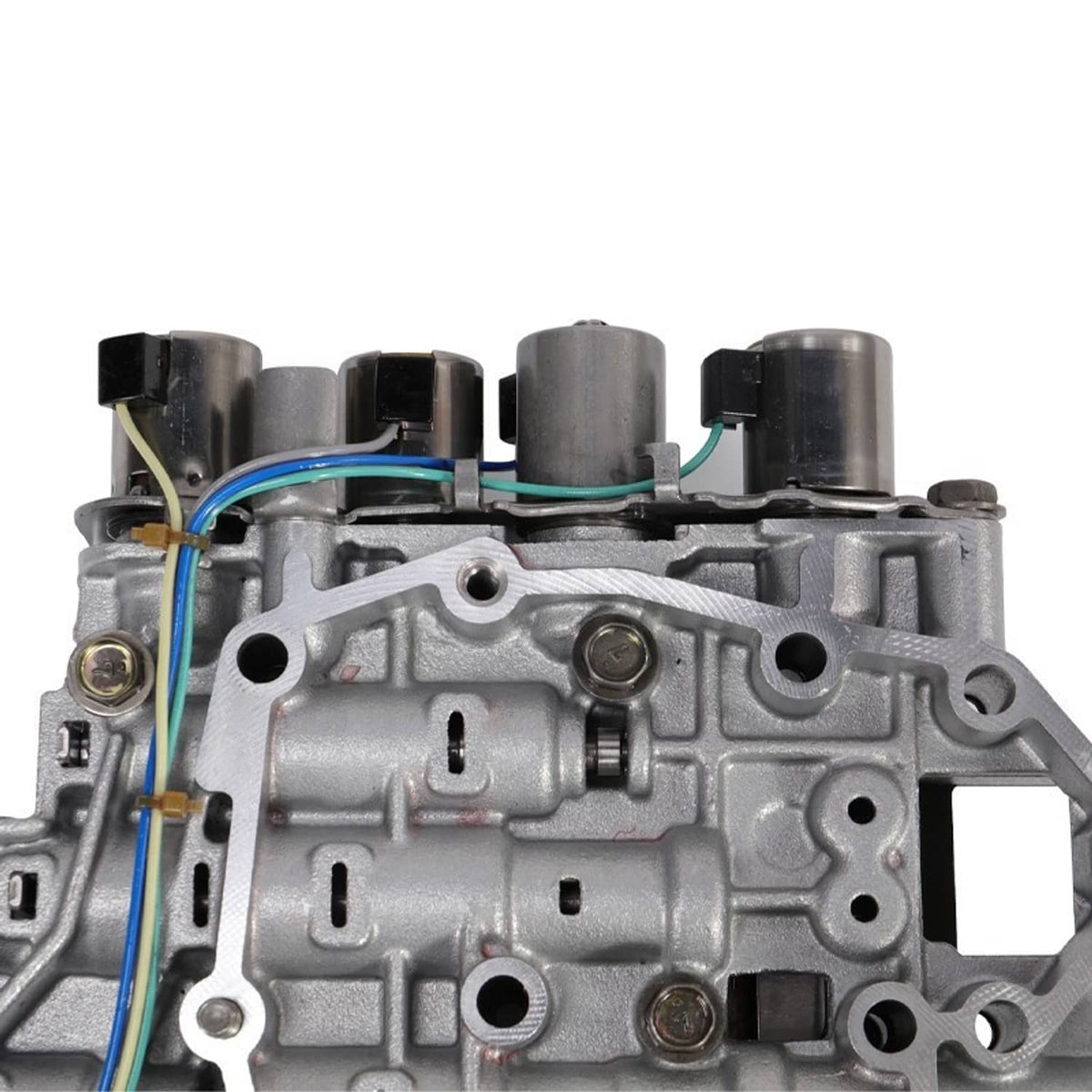 Transmission valve body with solenoid, close-up of housing ports and colored wires