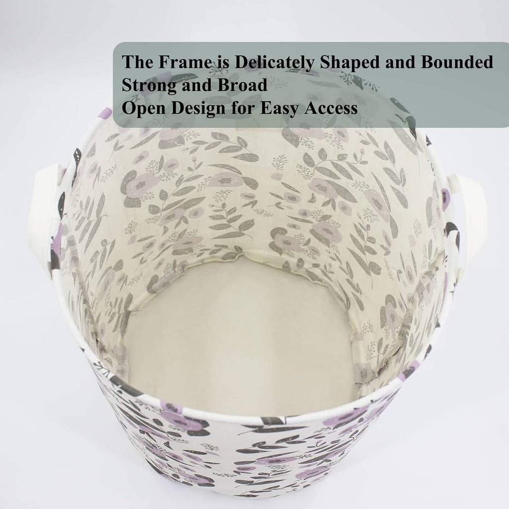 Open-top collapsible laundry basket with purple floral print, reinforced rim and handles.