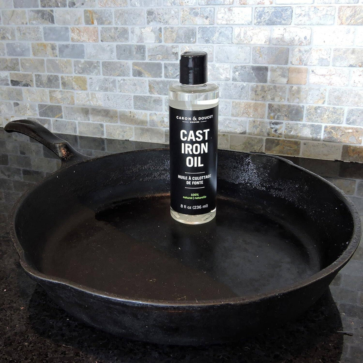 Caron & Doucet Cast Iron Oil bottle, black cap, 8 fl oz (236 ml) on front label.