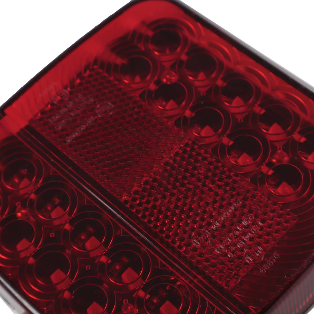 Extreme close-up of red LED lens with circular elements and diamond texture