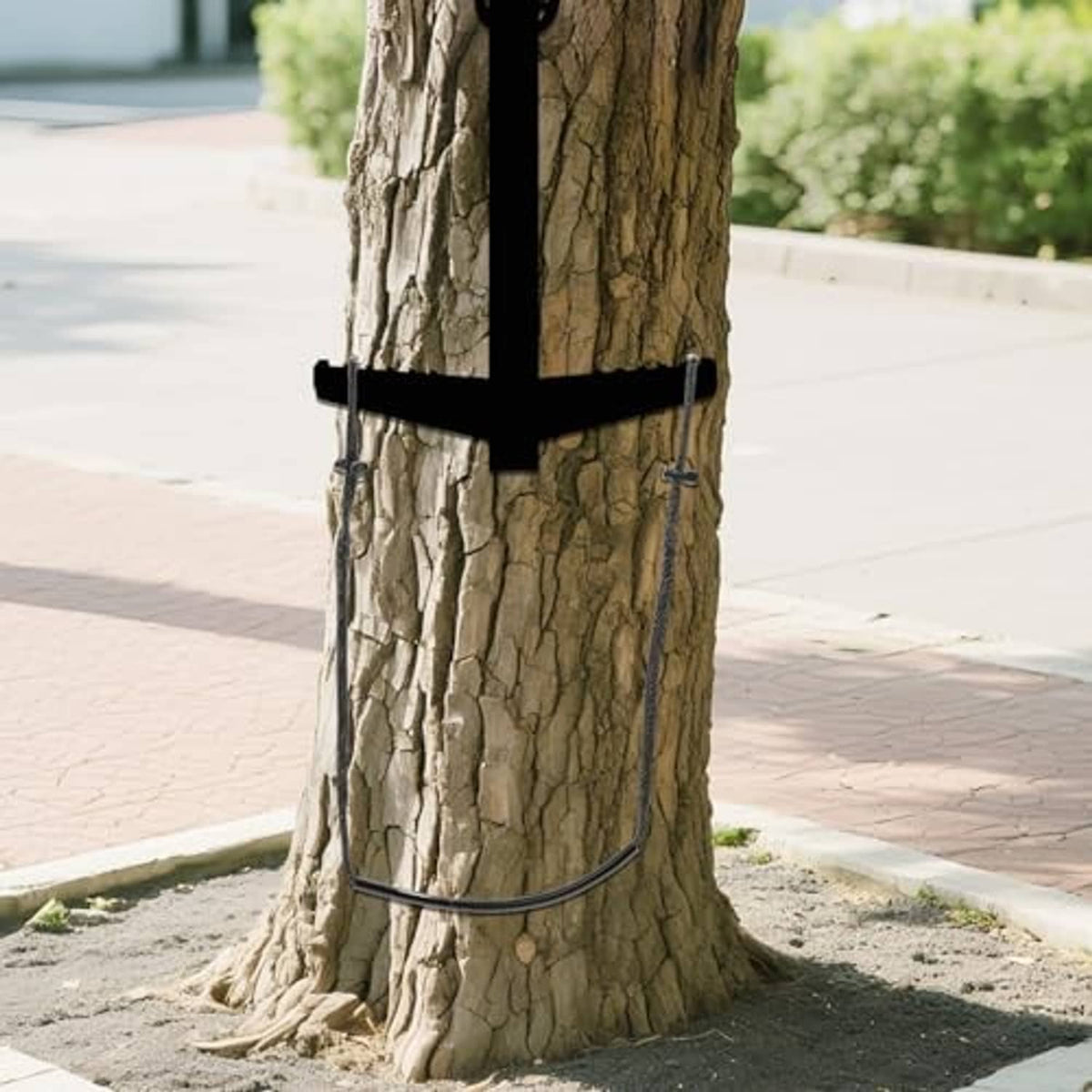 Climbing stick step aid attached to a tree trunk with braided rope and black tube