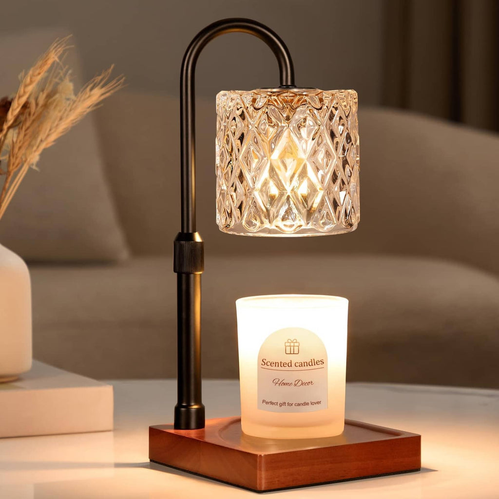 Black candle warmer lamp with cut-glass shade and white wax candle on wood base
