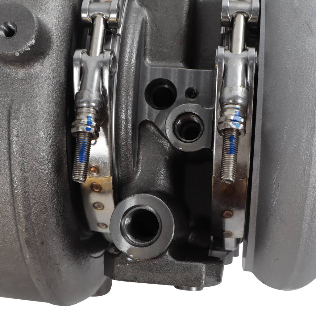 Diesel turbocharger close-up of linkage springs, metal connectors, and mounting plate