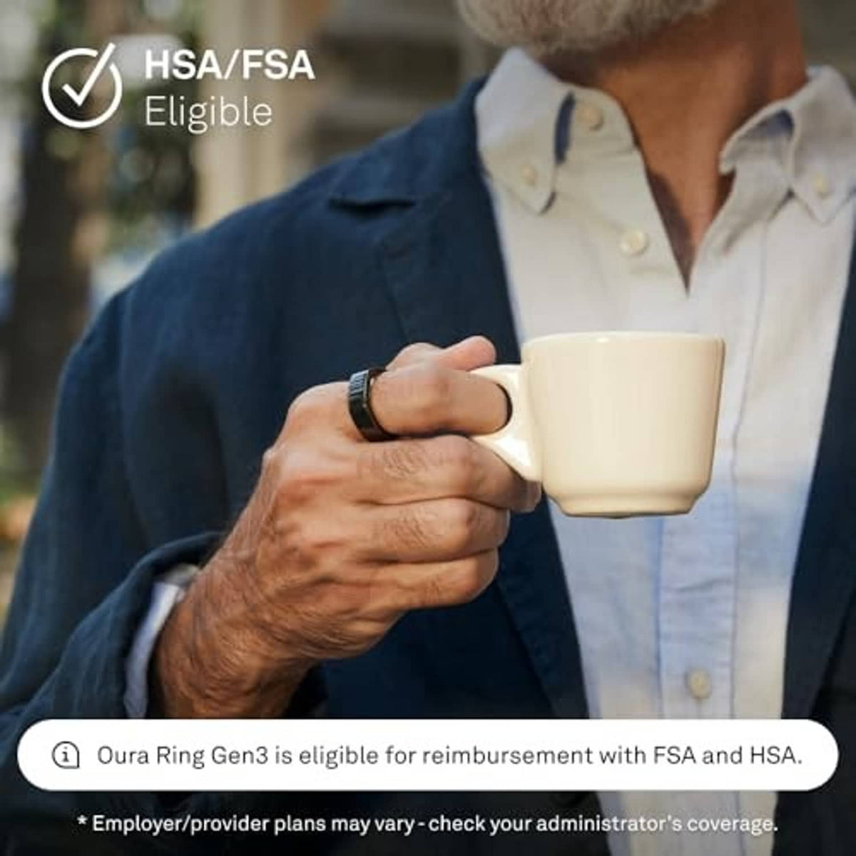 Oura black smart ring on finger while holding a mug