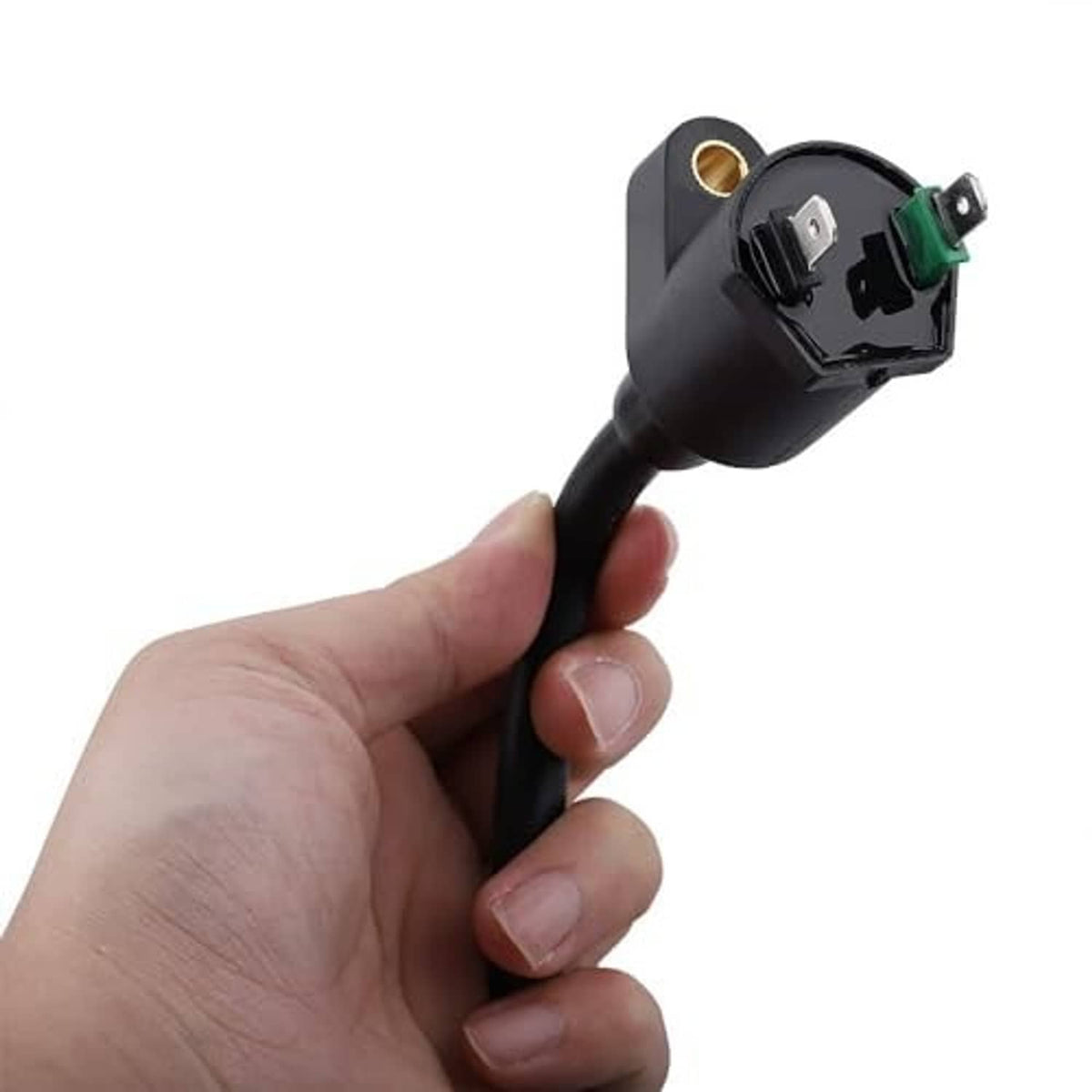 Ignition coil connector module with terminal pins and black wire, held in hand