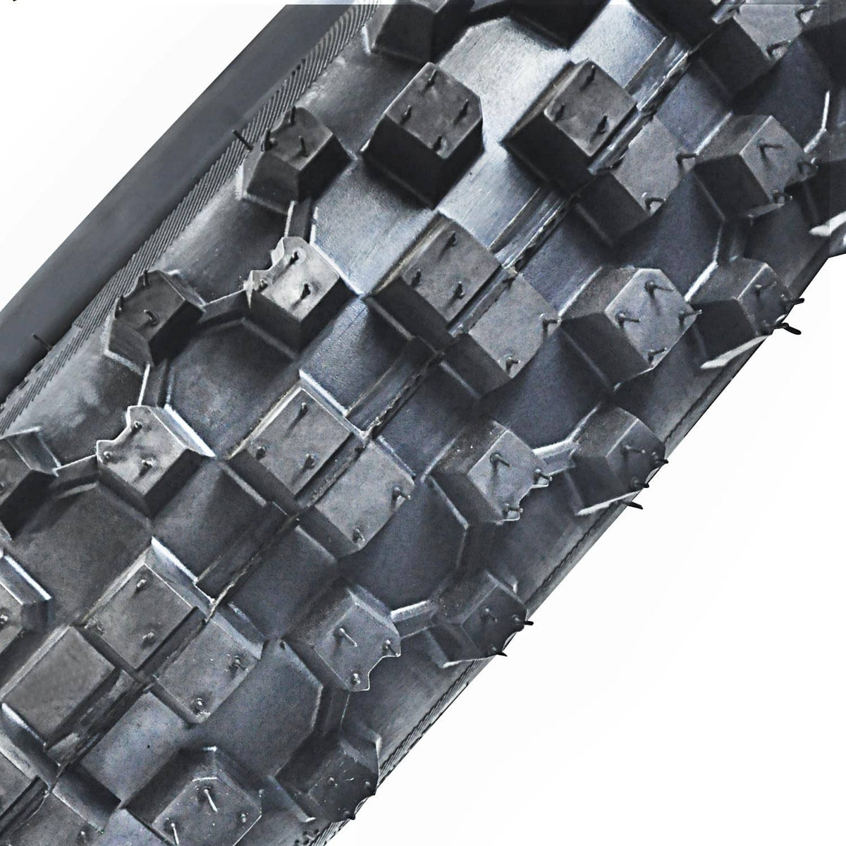 Close-up of knobby tire tread blocks on black rubber