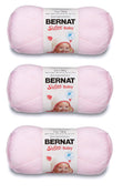 Light pink Bernat Softee Baby yarn skeins on display, labeled for knitting and crochet.