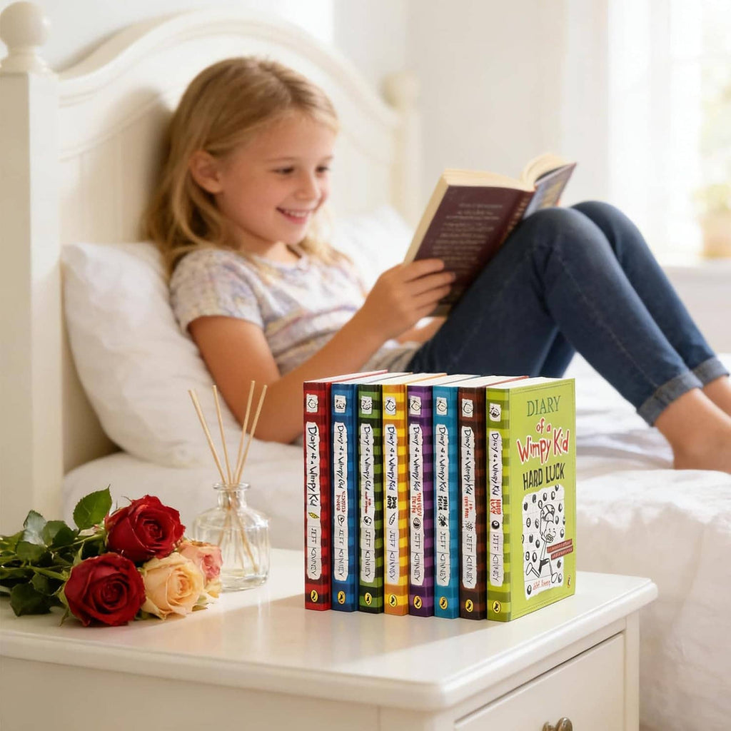 Diary of a Wimpy Kid book box set next to a child reading on a couch