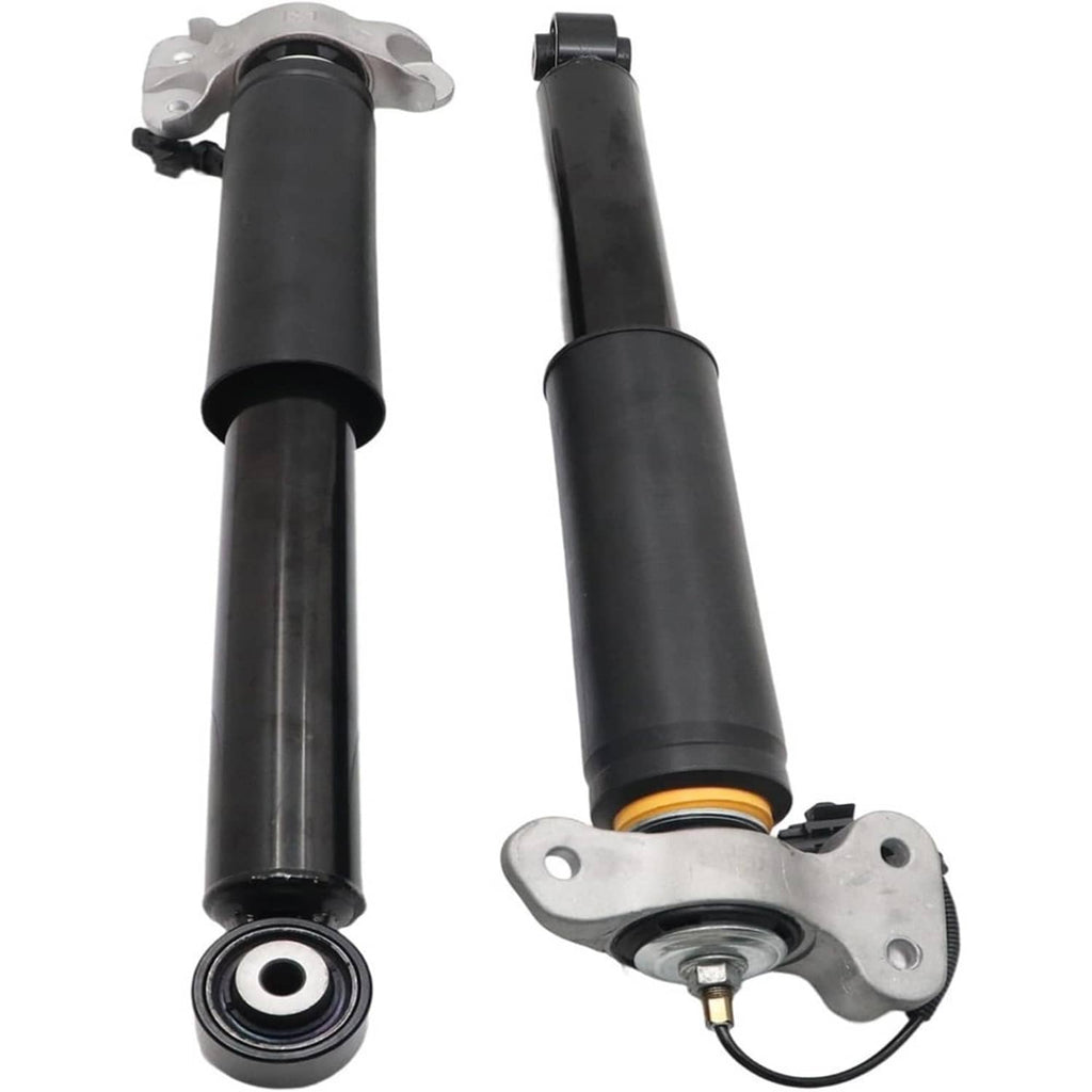 Pair of black rear shock absorber struts with mounting plates, bushing ends, and wire leads