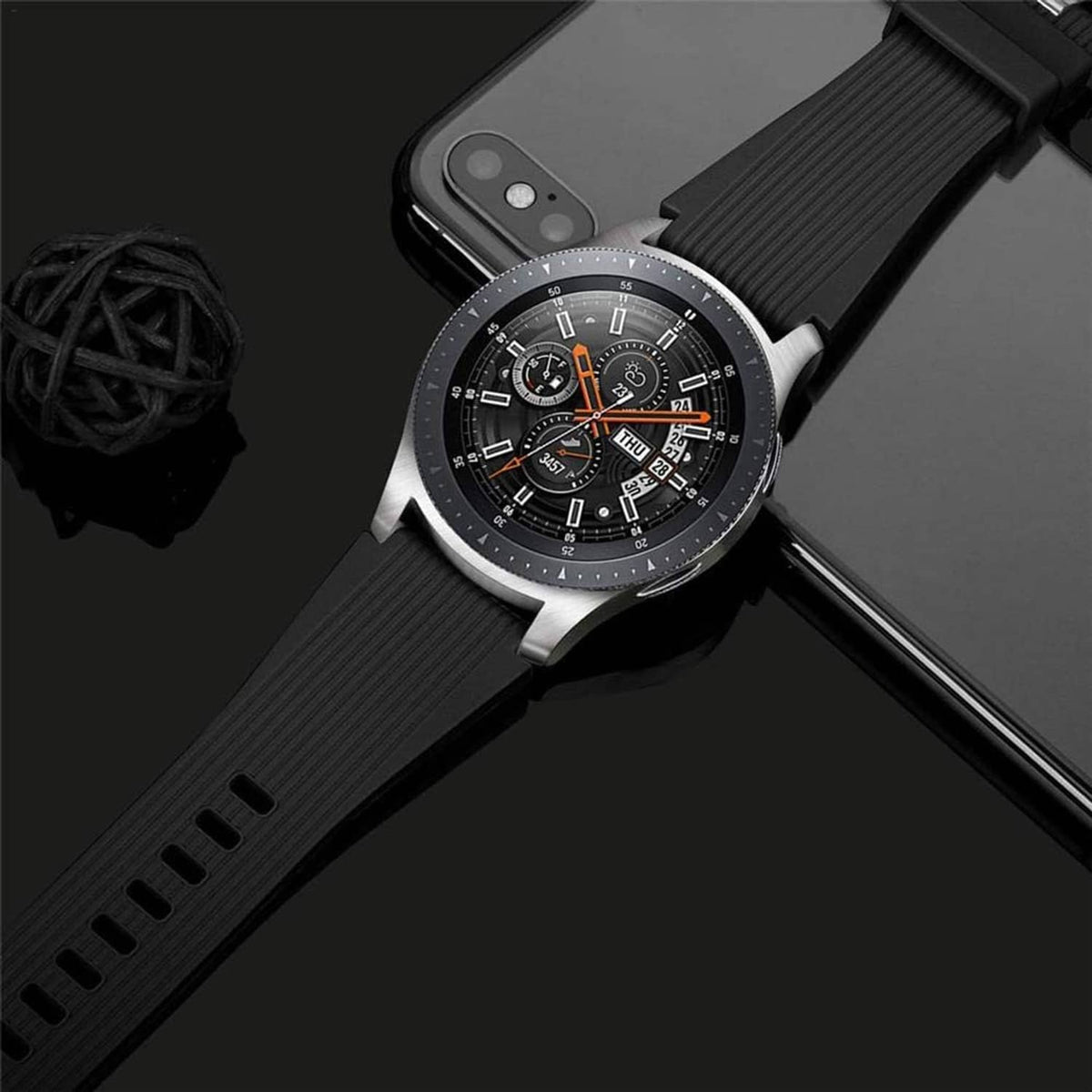 Black silicone watch band with ridged texture on round smartwatch with silver case