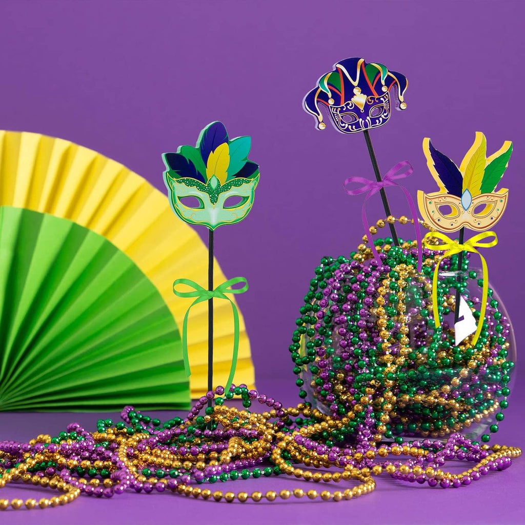 3 wooden Mardi Gras centerpieces with mask toppers, ribbon bows, and colorful square bases