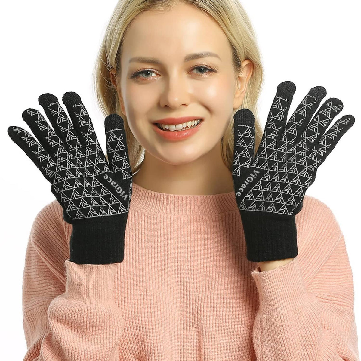 Black knit touchscreen gloves worn by a woman with geometric pattern on fingertips