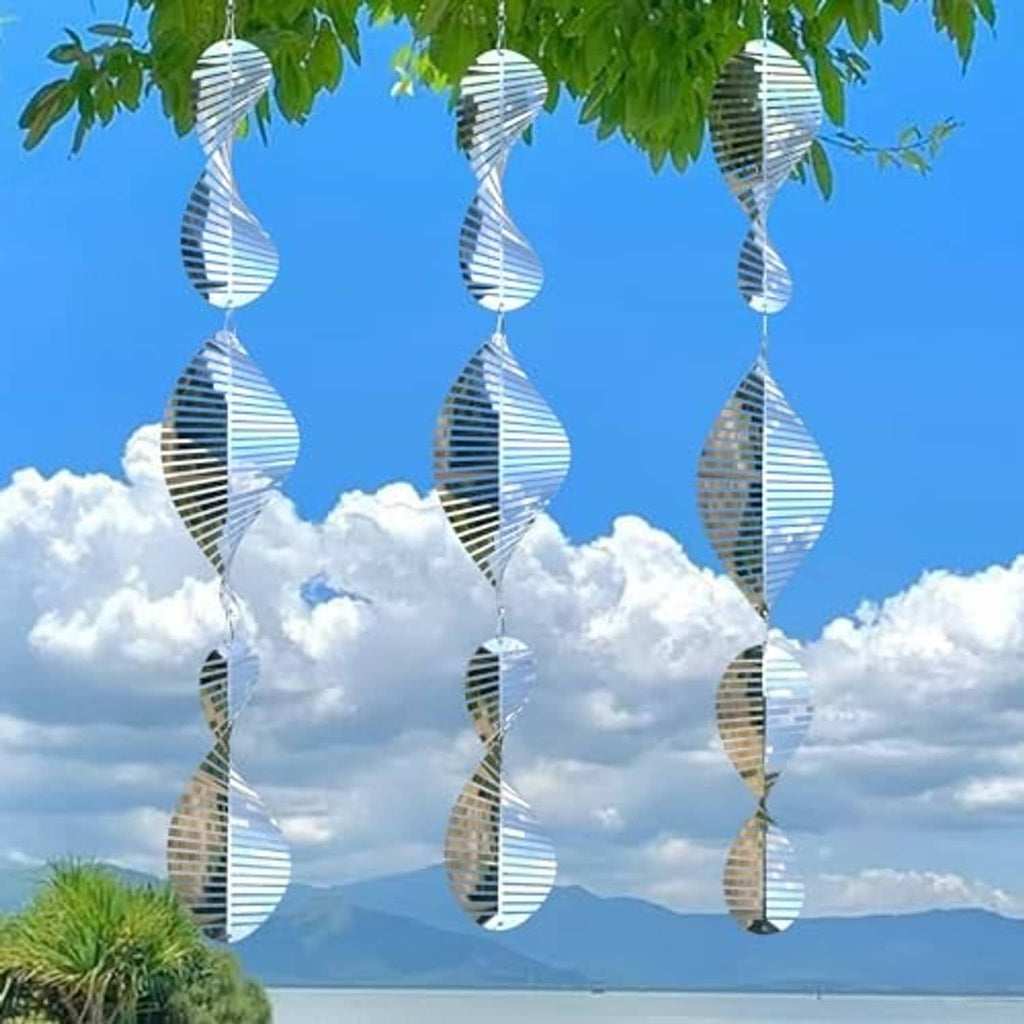 Reflective stainless steel wind spinner discs hanging in a row from metal hooks