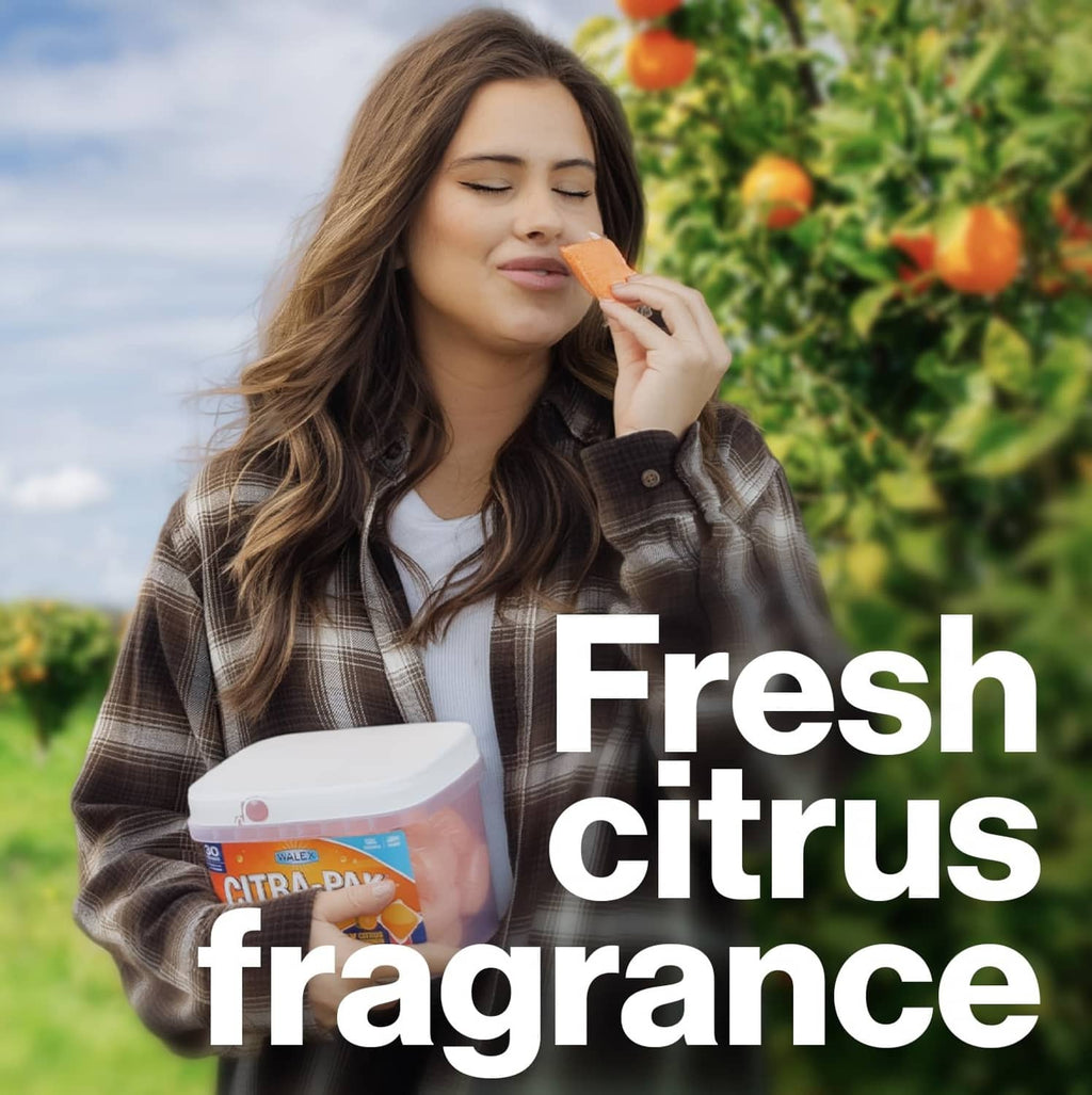 Person holding a Citra-Pak RV toilet treatment tub with fresh citrus fragrance